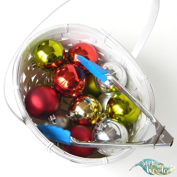 Picking up ornaments with tongs is a fun Christmas themed fine motor activity for toddlers and preschoolers. 